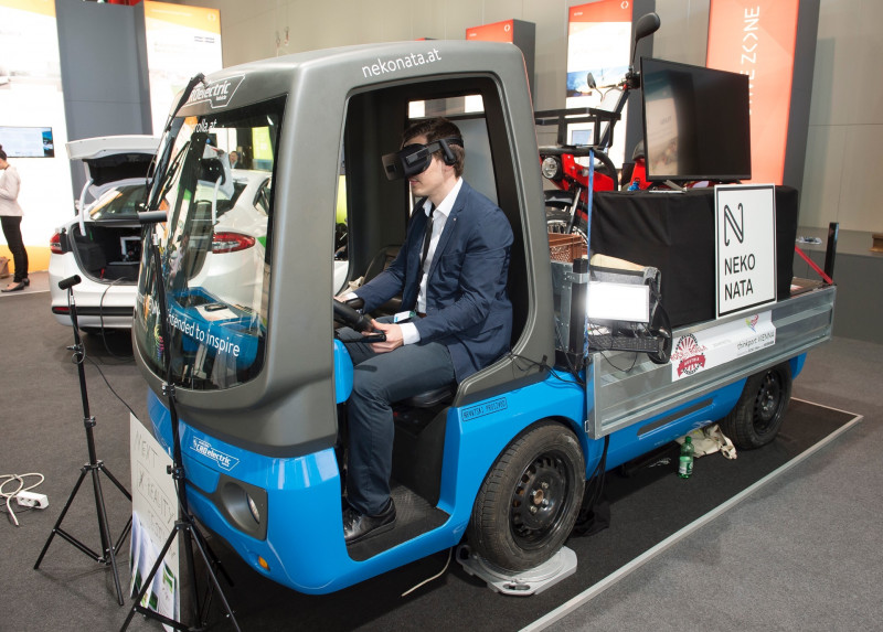 Person in a suit with virtual reality glasses in a mini-truck